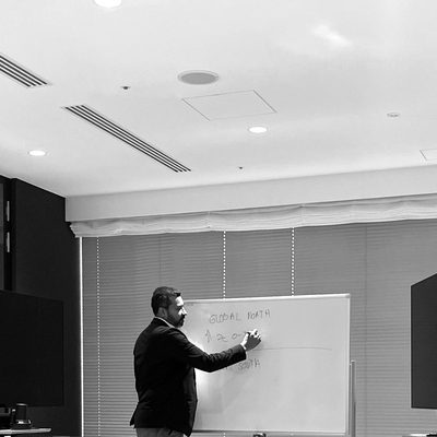 Ulrick at a whiteboard during a working session in Japan